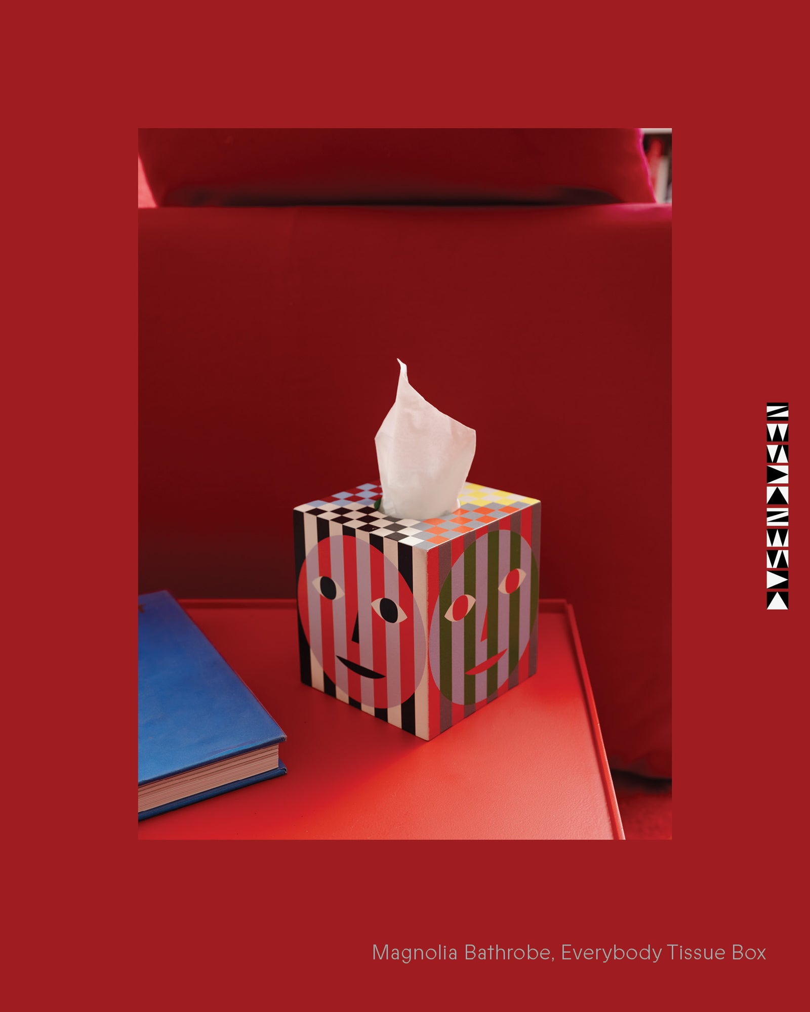 Tissue box with a face design on a red background