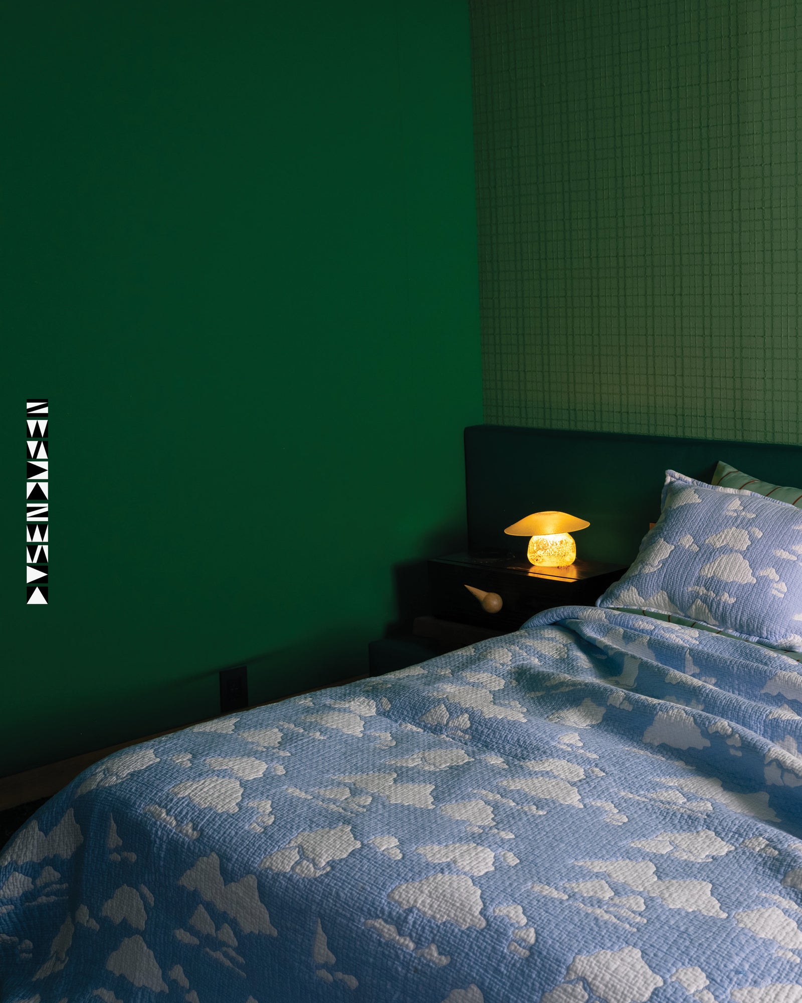 Cloud coverlet with caption "Photography by Brian W Ferry, at the home of Brock Forsblom and Jeremy Heimans. Modeled by Kara Jackson