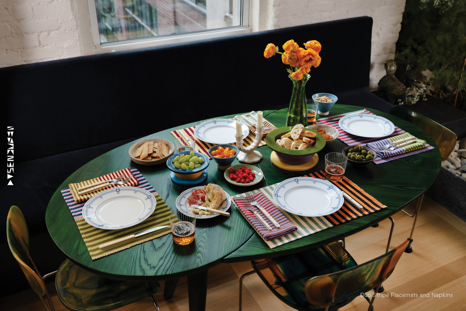 Dining table set with plates, glasses, and food with Duo Stripe Napkins and Duo Stripe Placemats