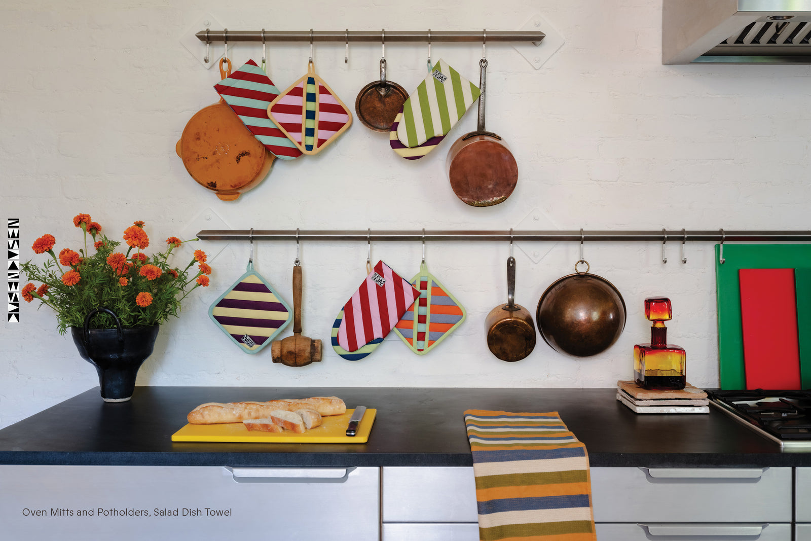 Kitchen with hanging pots oven mitts and dish towels