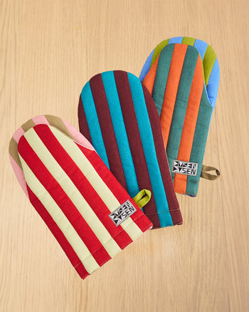 ["Colorful striped oven mitts on a wooden surface"]