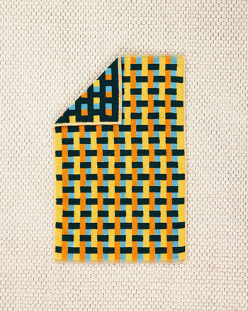 Yellow Folded Weave Towel on Floor