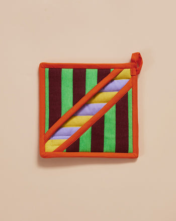 Dusen Dusen Stripe Pot Holder. Features a square pocket shape, top stitched brand label, and a side loop. 100% cotton quilted canvas base, with polyester fill. Stripe Pot Holder with contrast yellow, purple, green and Brown stripe pattern with an orange trim