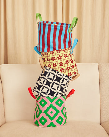 ["Stack of colorful fabric storage bins on a beige couch with a beige curtain background. ", " Perfect for little messes (we can't help with the really big messes)"]