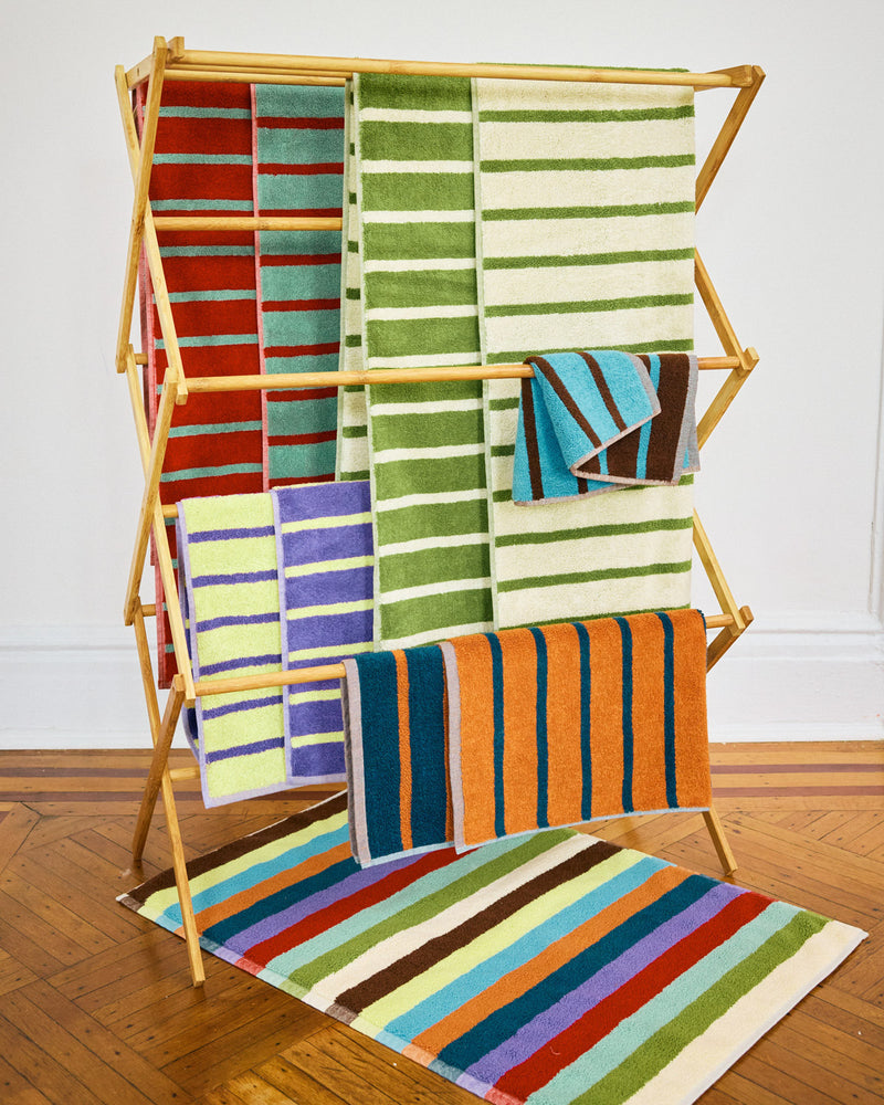 Set of 5 bird stripe towels with bath mat on floor 