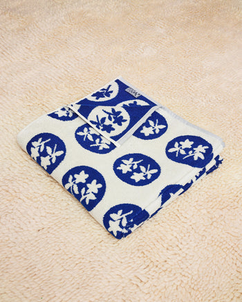 Bouquet Towel folded on a cream rug 
