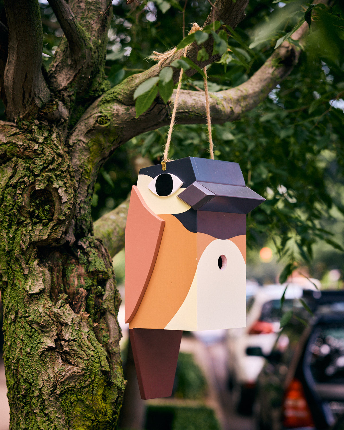 Brown chickadee birdhouse hanging in tree