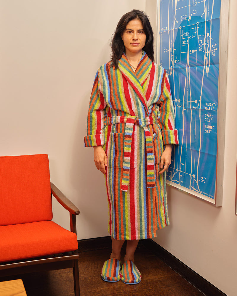 ["A woman wearing a colorful vertically striped bathrobe and matching slippers stands in an indoor room with a blue framed print on the wall and an orange chair at left. ", " For social butterflies, and butterflies who would rather just stay home <br> <br> Ana is 5'5\" and wears a size S, Jessica is 5'6\" and wears a size S, Jesse is 6'1\" and wears a size L"]
