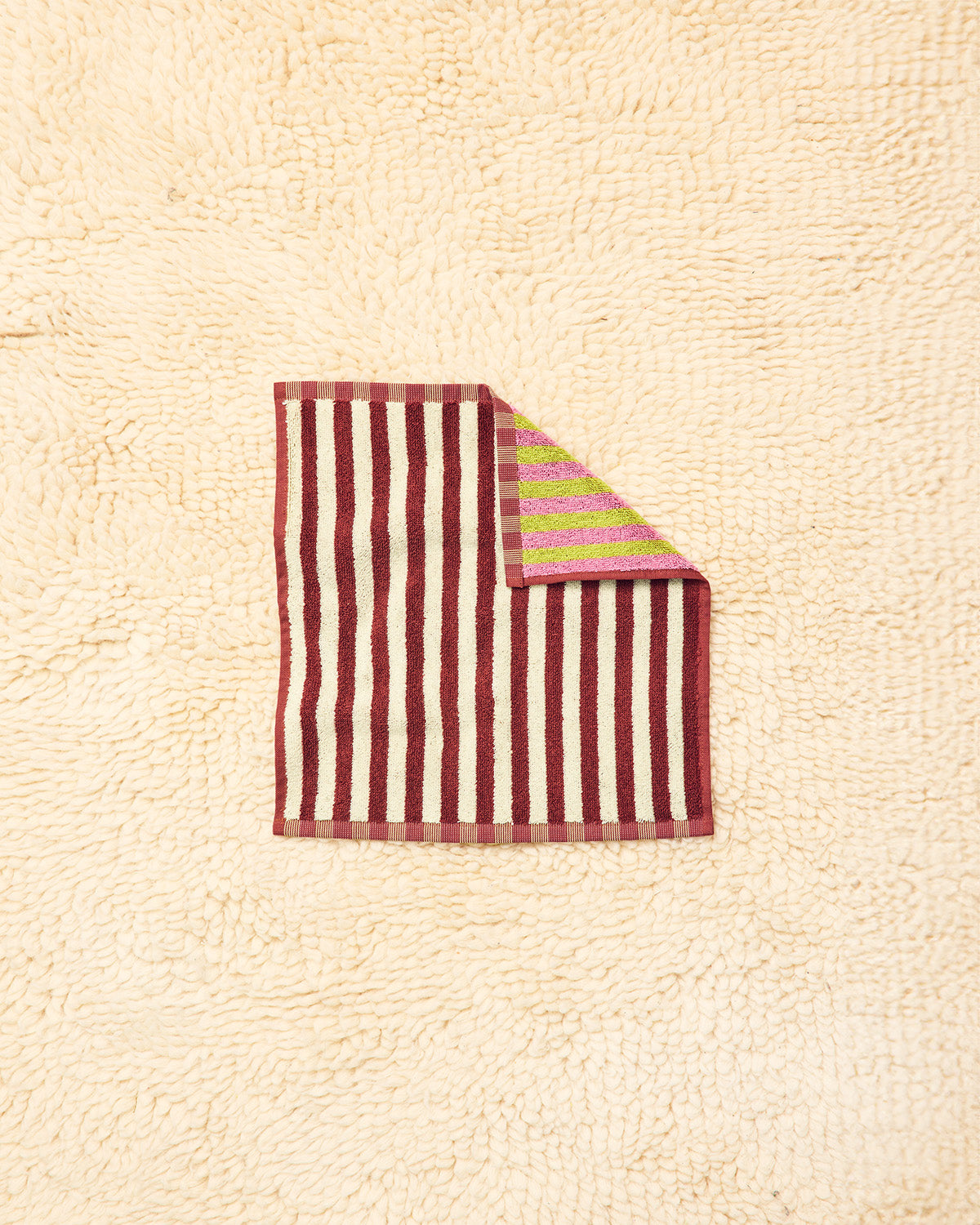 Caterpillar washcloth in maroon, white, pink, and green