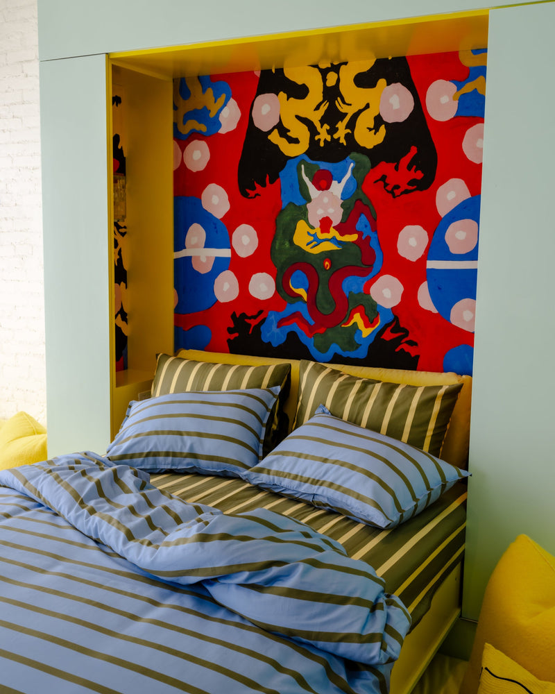 ["Bedroom with colorful abstract wall art and striped bedding", " ", " The stripes are stems and you are the little bee taking a nap inside"]