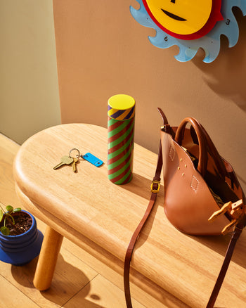 Stripe water bottle on bench with keys 