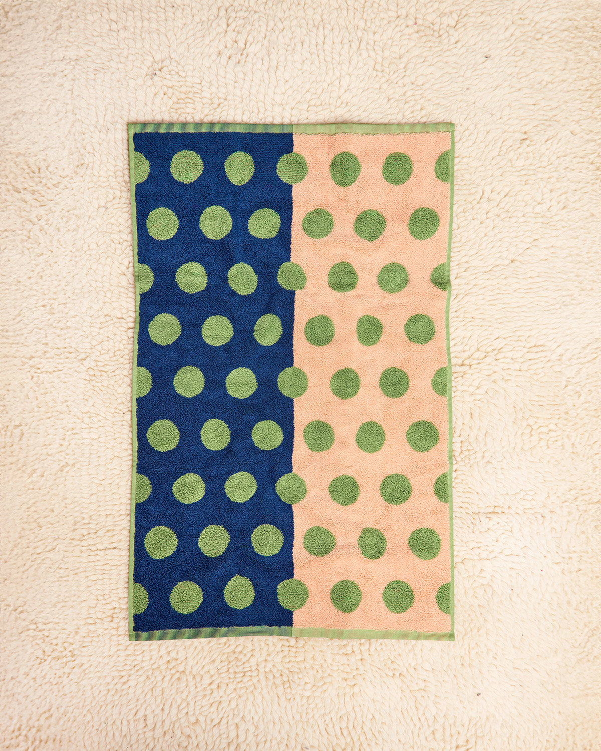 Two-section towel with green polka dots on a beige background 