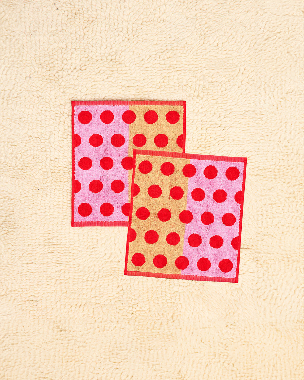 Washcloths with red polka dots on a beige background