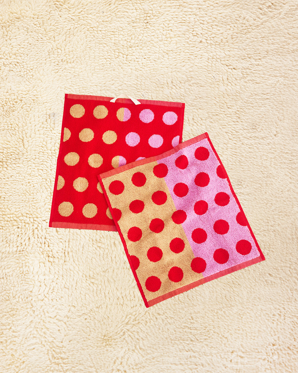Washcloths with red polka dots on a beige background