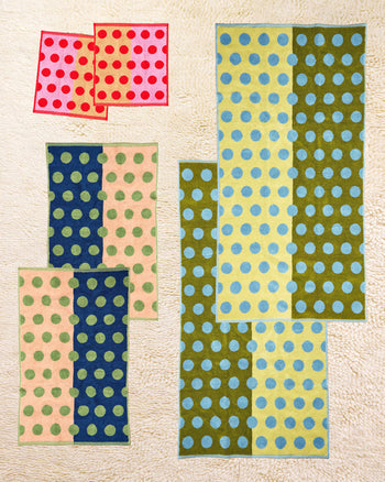 Set of colorful polka dot towels on a beige background