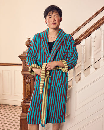 ["A man wearing a vibrant blue and maroon vertically striped bathrobe with gold trim, standing in front of an indoor staircase.", " For those who like to make a little splash <br><br> Jesse is 6'1\" and wears a size L, Jessica is 5'6\" and wears a size S"]