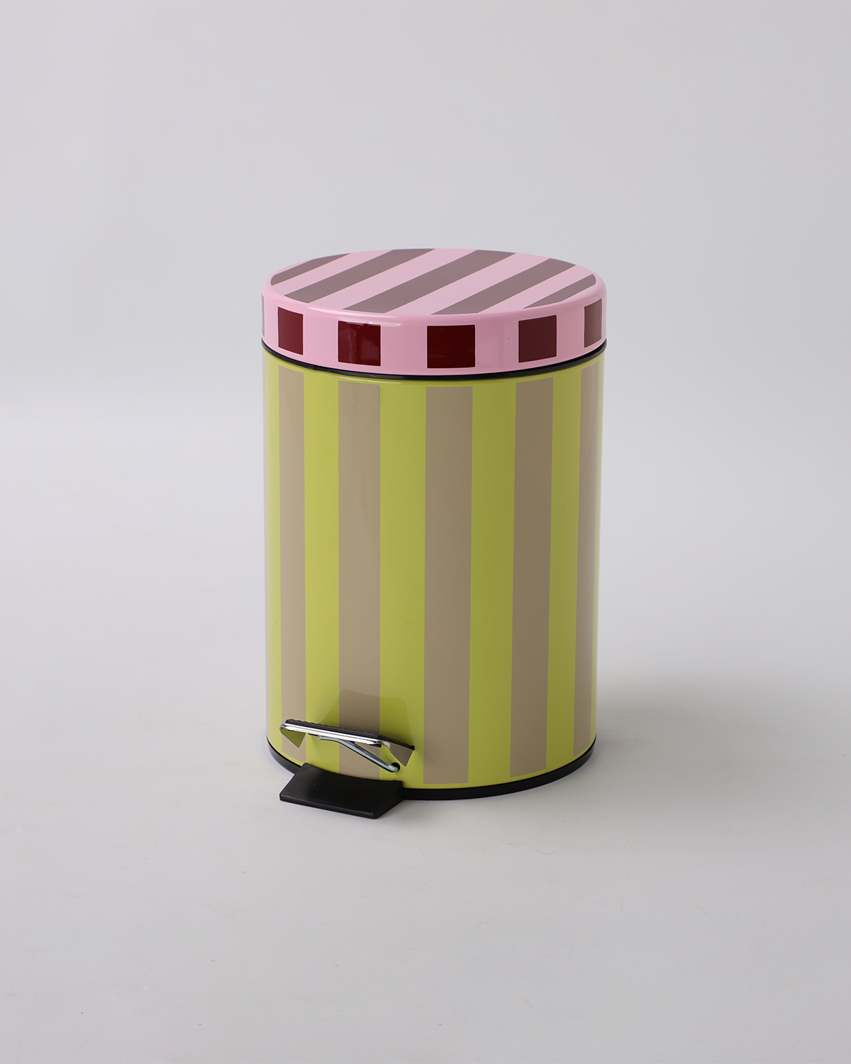 Striped trash can with pink and green pattern on a light gray background
