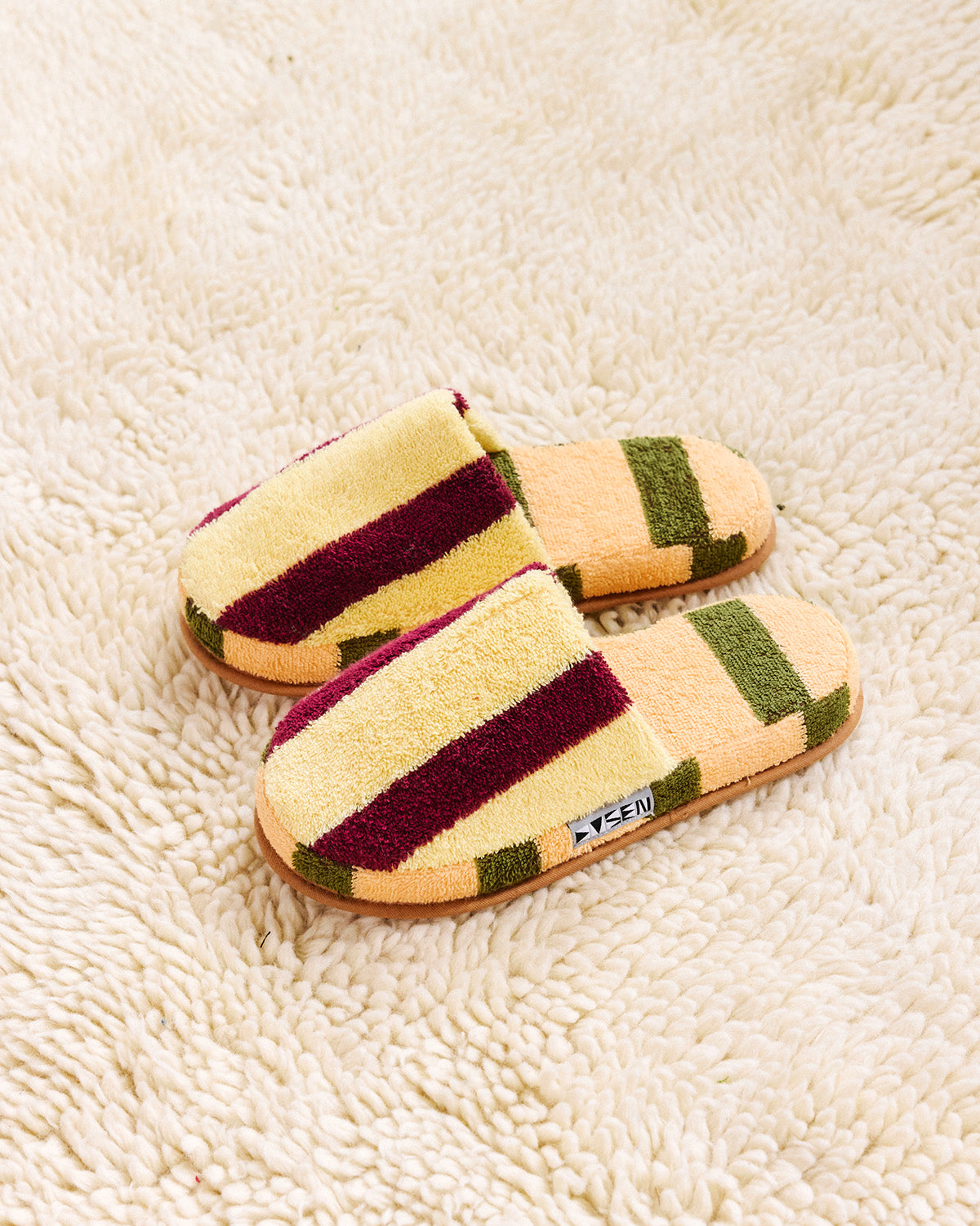 pair of ginkgo slippers on a white carpet