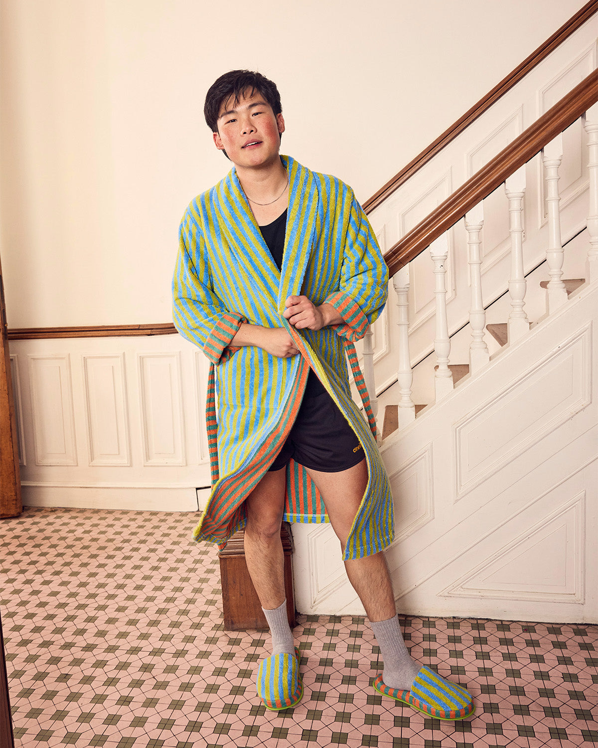 Jesse wears a blue and chartreuse bathrobe in Grasshopper