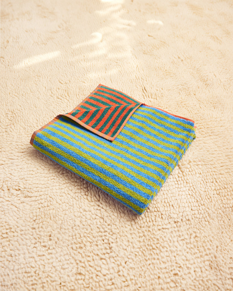 Colorful striped towel in blue green, dark green and orange