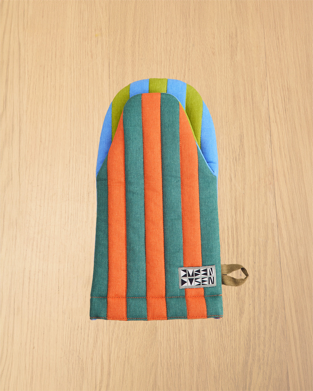 Grasshopper oven mitt on wooden table