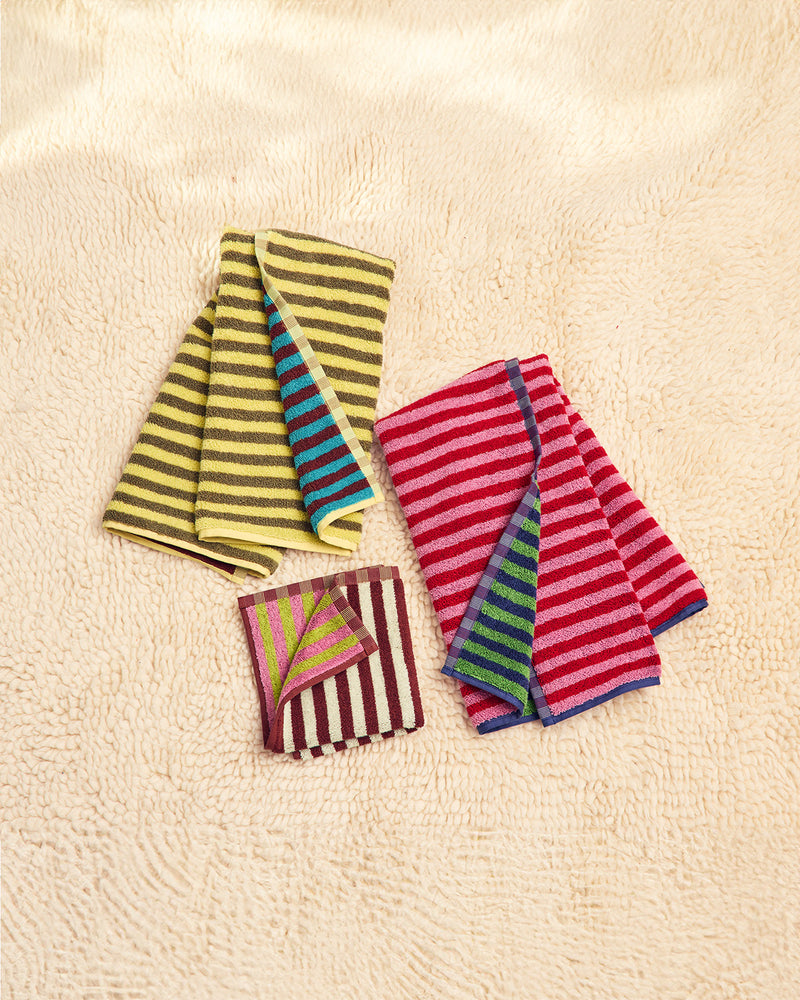 Three colorful bug towels on a carpet 