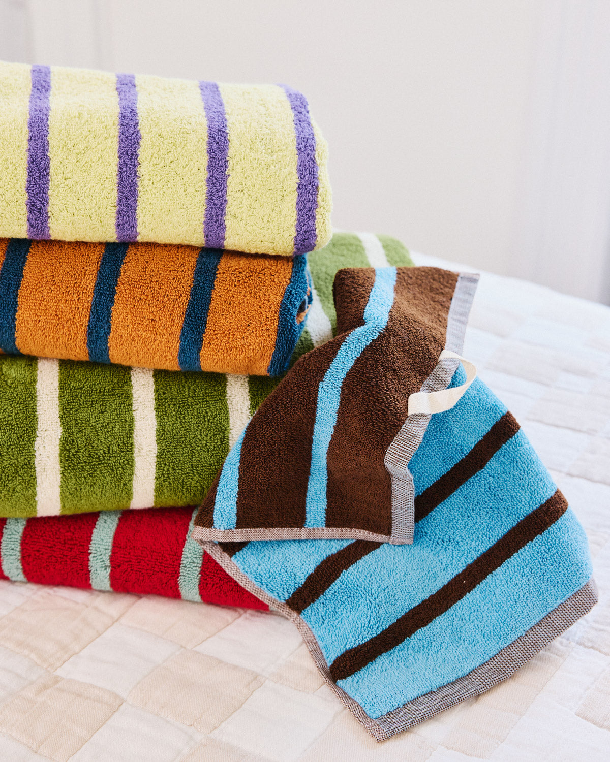 Stack of towels with heron washcloth detail