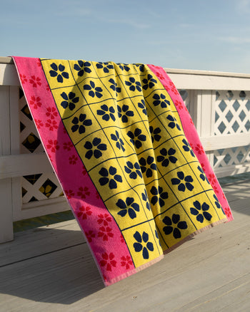 Colorful towel with floral pattern on a wooden deck