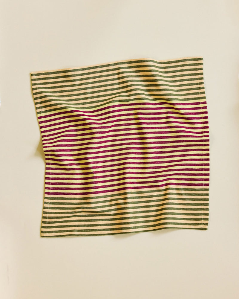 Striped fabric with green and red pattern on a beige background
