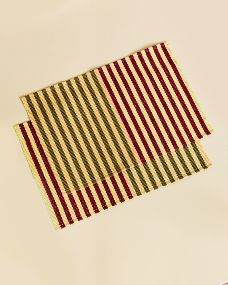 Two honey stripe placemats on beige background