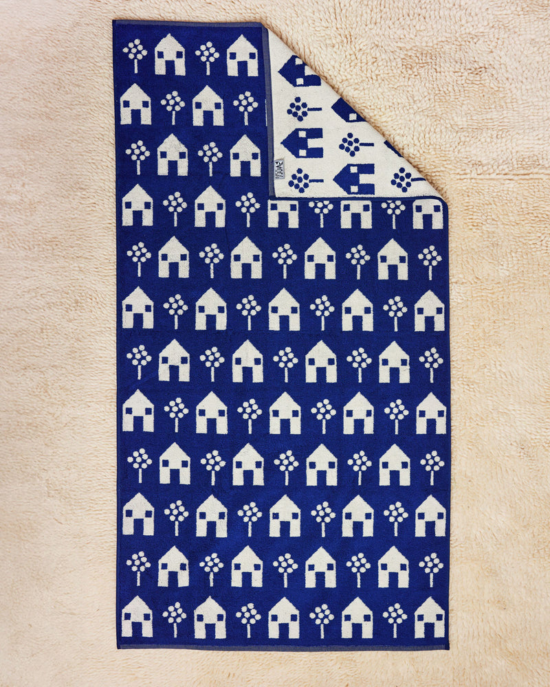 House Towel Navy and White Flat on cream rug 