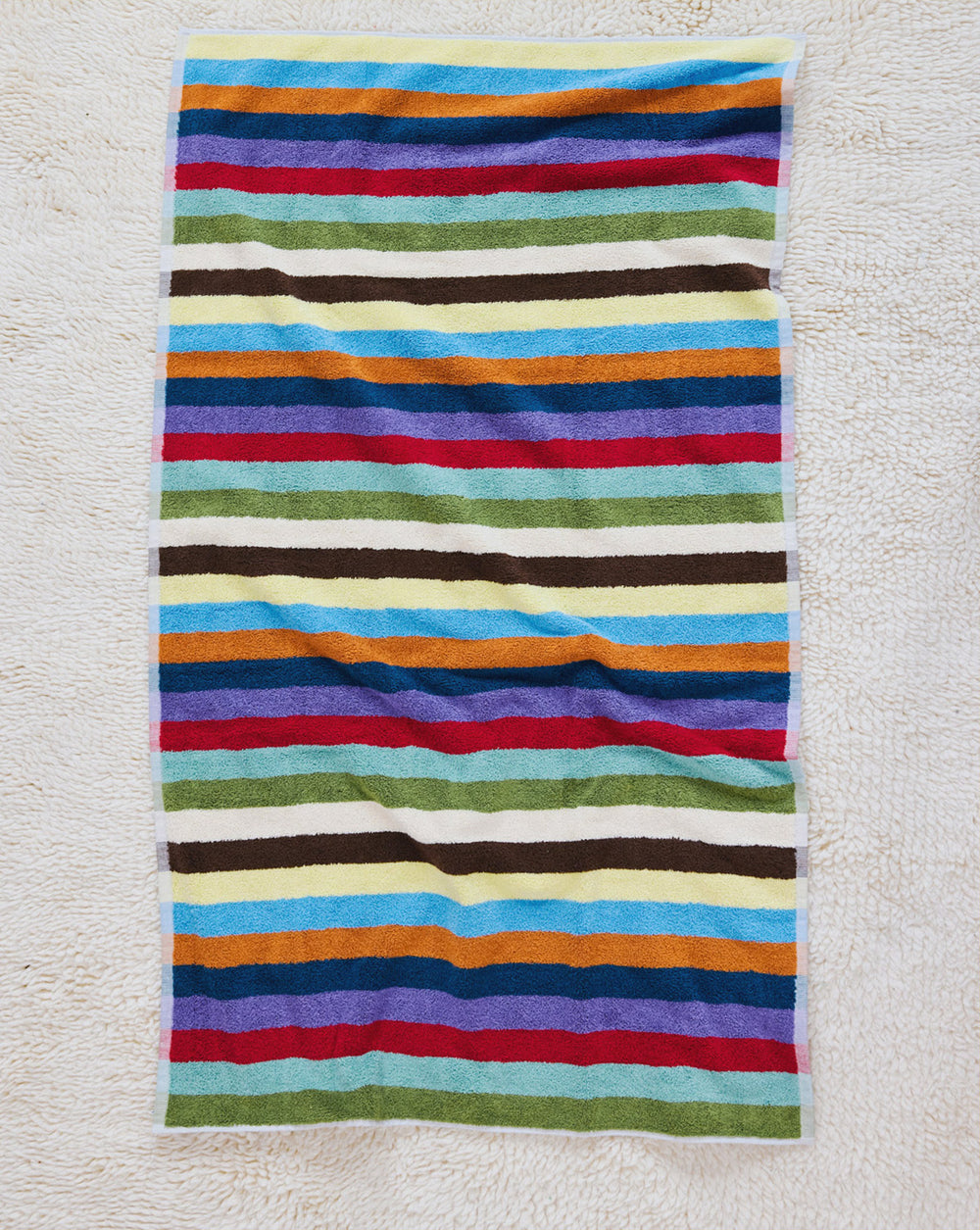 Hummingbird bath towel on carpet
