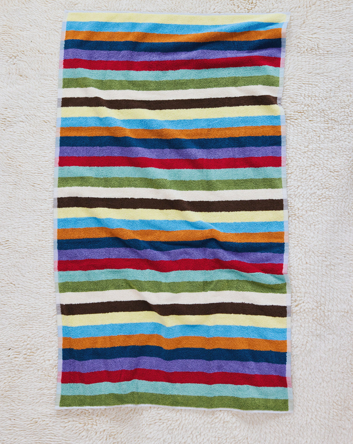 Hummingbird bath towel on carpet