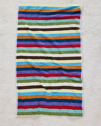 Hummingbird bath towel on carpet