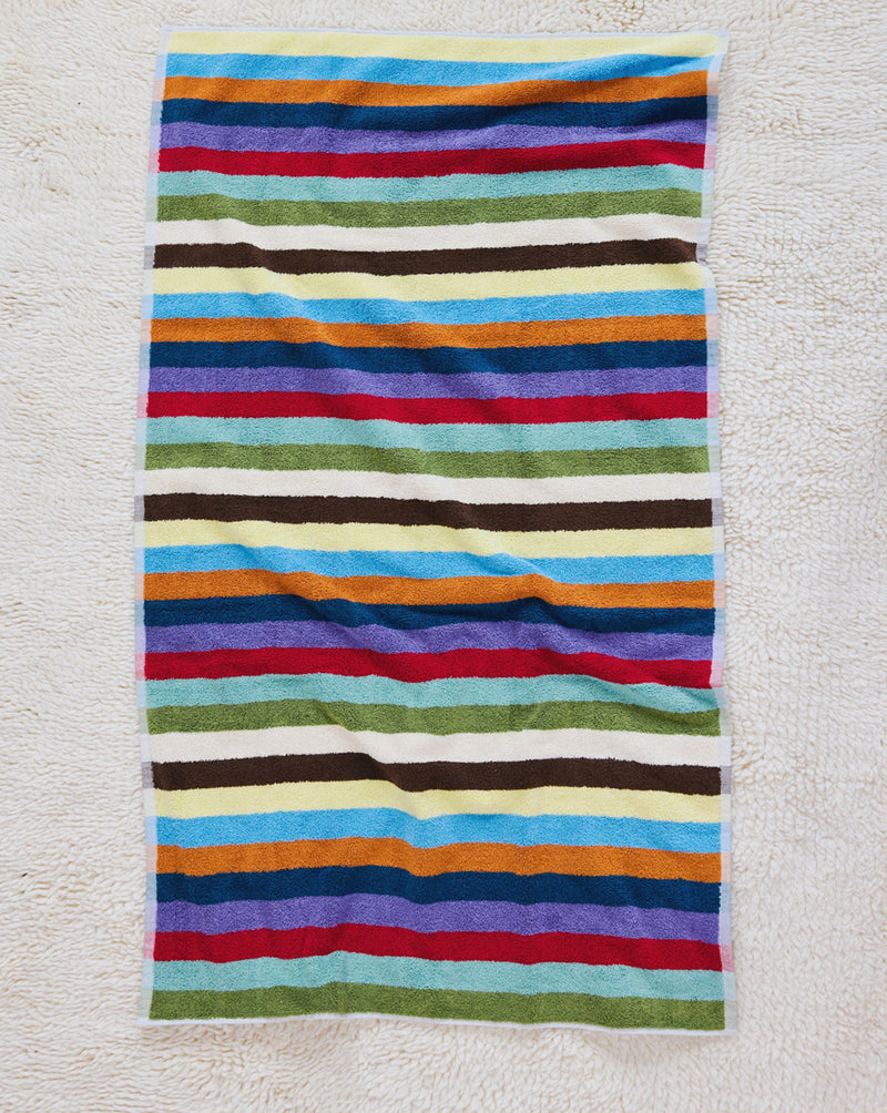 Hummingbird bath towel on carpet