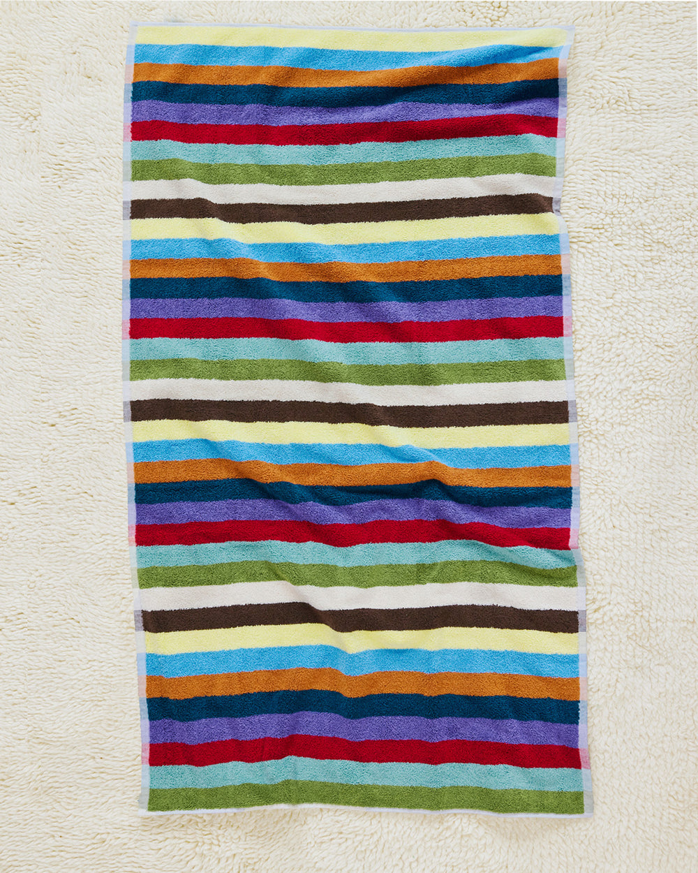 Hummingbird bath towel on carpet