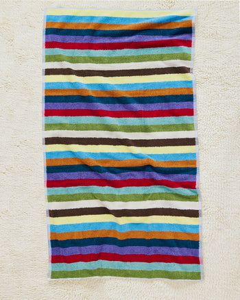 Hummingbird bath towel on carpet