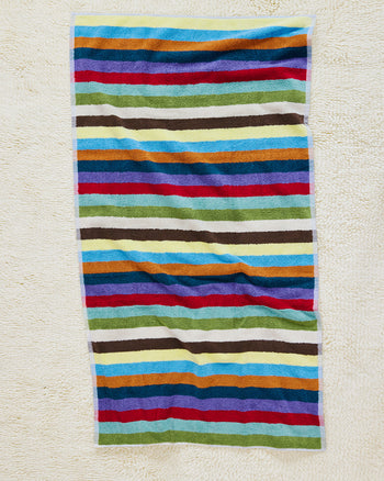 Hummingbird bath towel on carpet