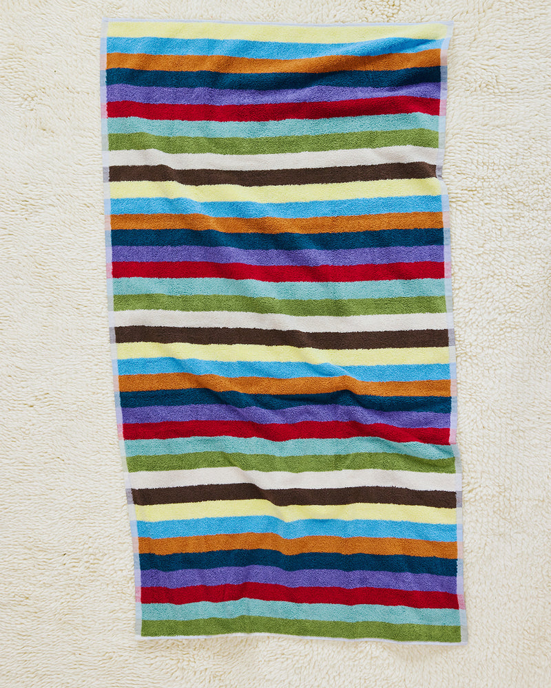 Hummingbird bath towel on carpet