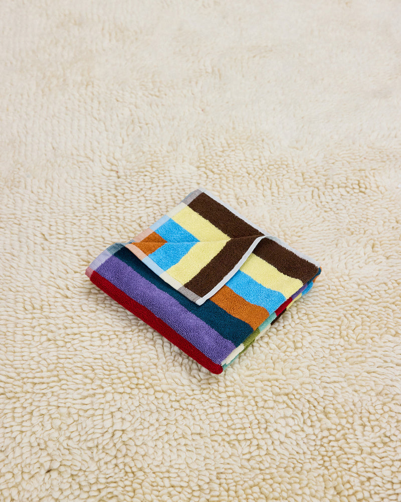 Hummingbird han towel on beige carpet
