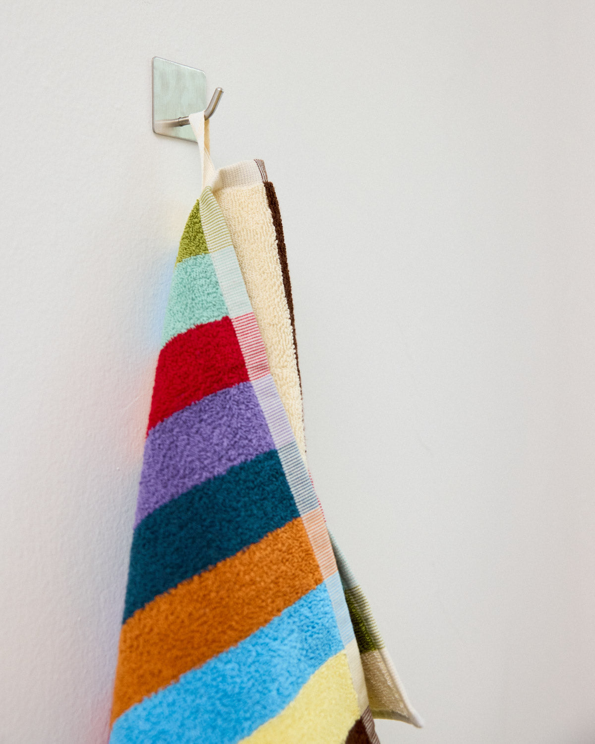 Close up of hand towel hanging loop hummingbird stripe