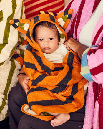 Baby wrapped in hooded towel