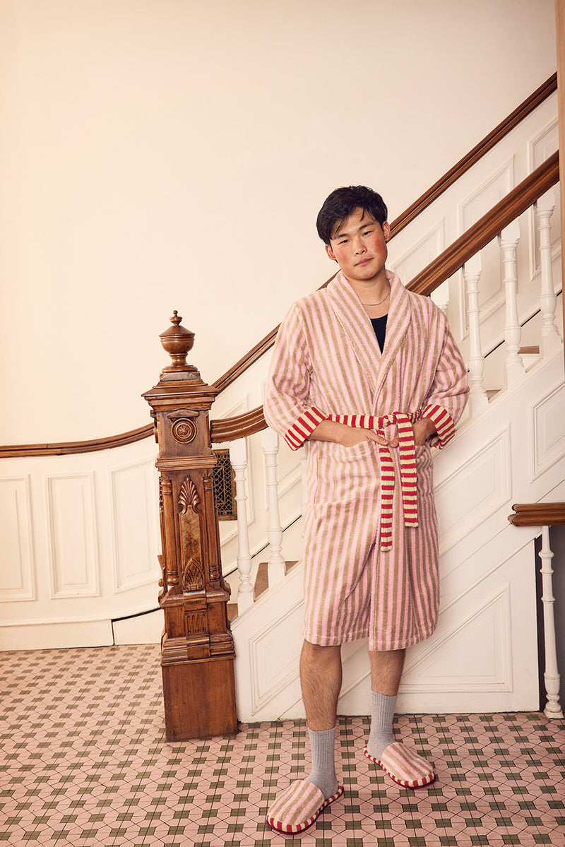 Jesse in a ladybug bathrobe in front of a staircase