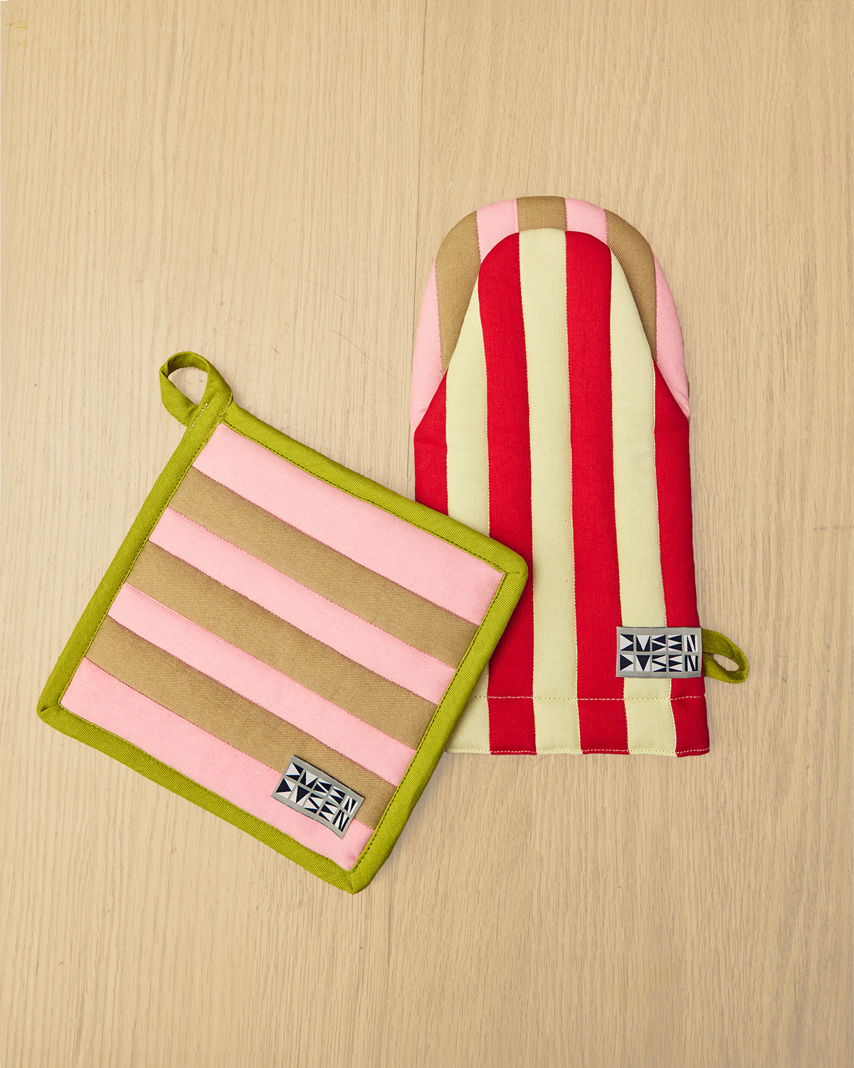 Striped pot holder and oven mitt on a wooden surface 