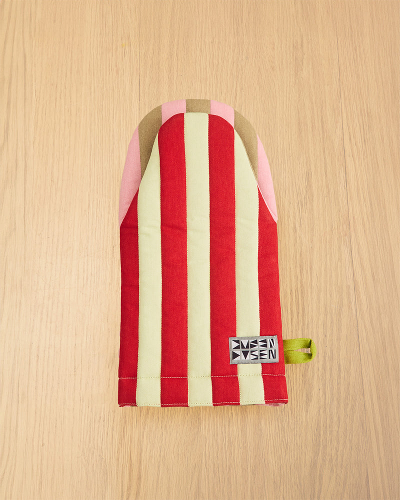 Red and white striped pouch with a visible brand label on a wooden surface
