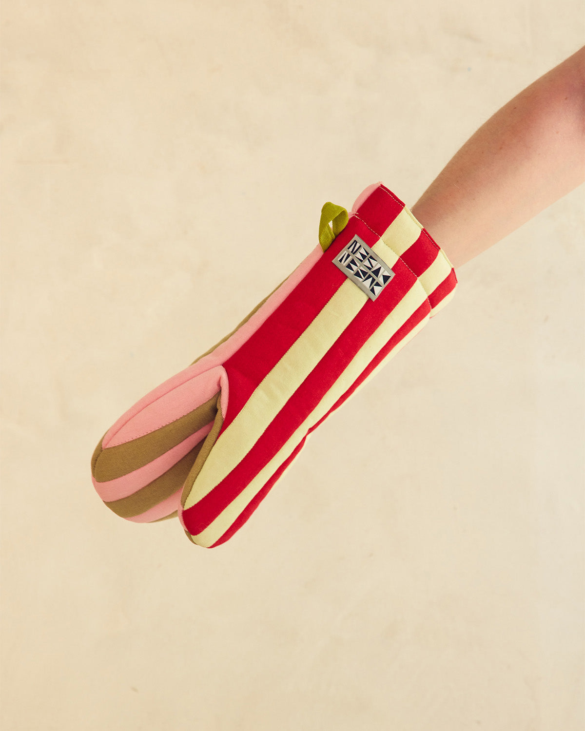 red and light green striped oven mitt with hand 