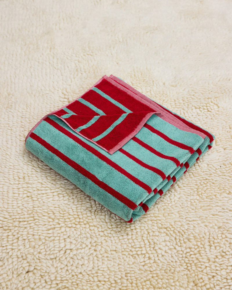 blue and red stripe towel on rug