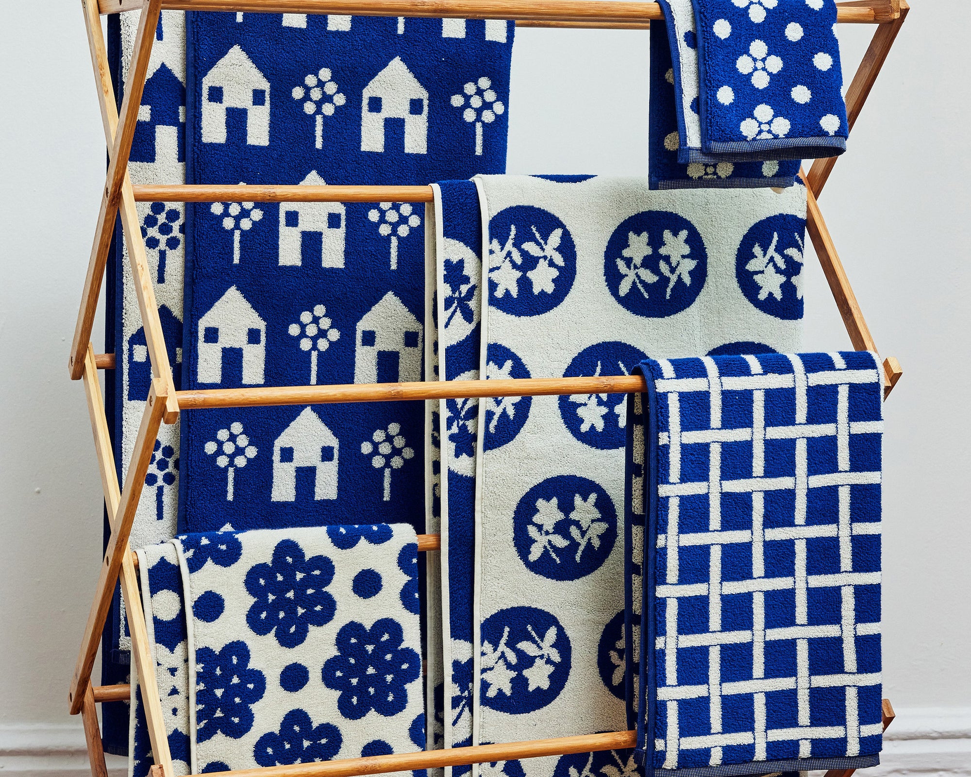 Set of Navy towels all on a rack hanging together