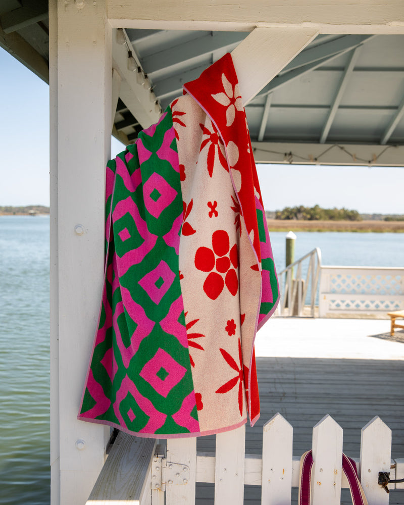 Peony towel hanging over wooden support on dock
