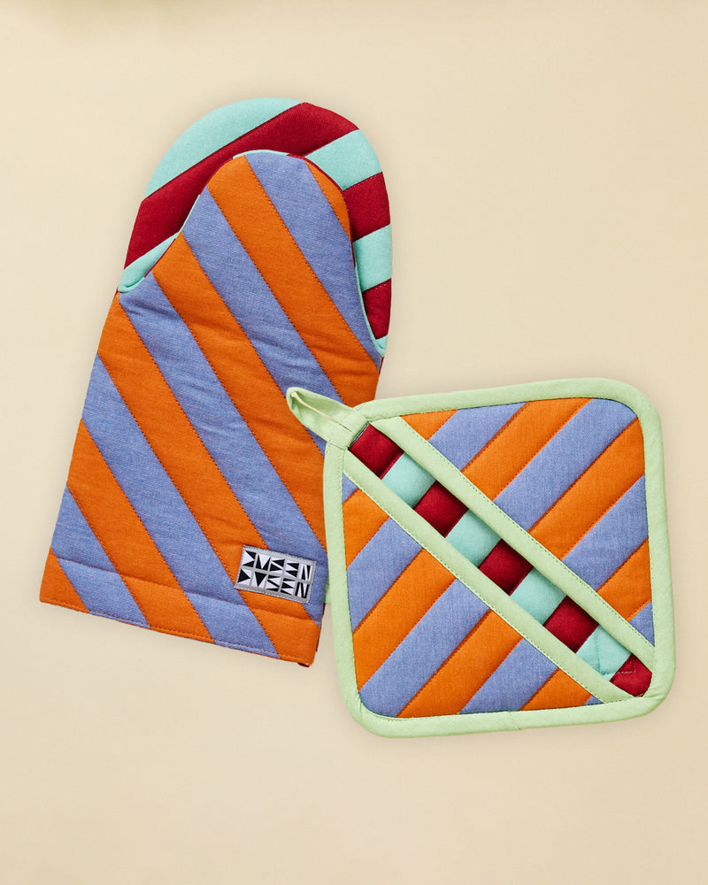 Colorful striped oven mitt and pot holder on a beige background 